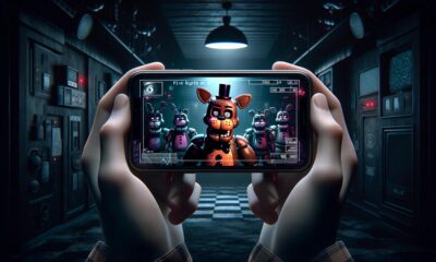 Smartphone mostrando FNAF 2 en un entorno oscuro, resaltando la tensión del juego.