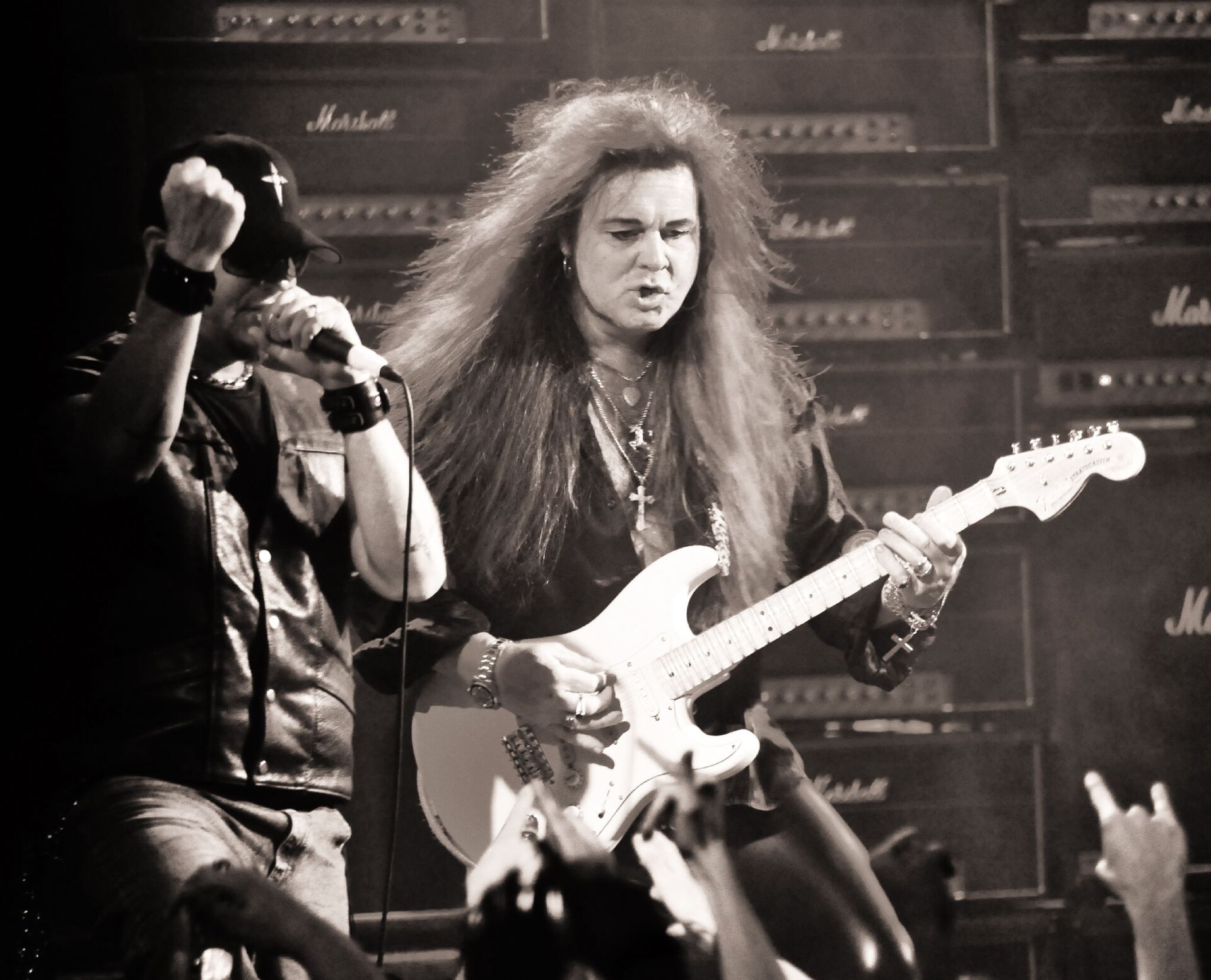 Yngwie Malmsteen tocando su guitarra frente a una pared de amplificadores Marshall en un concierto
